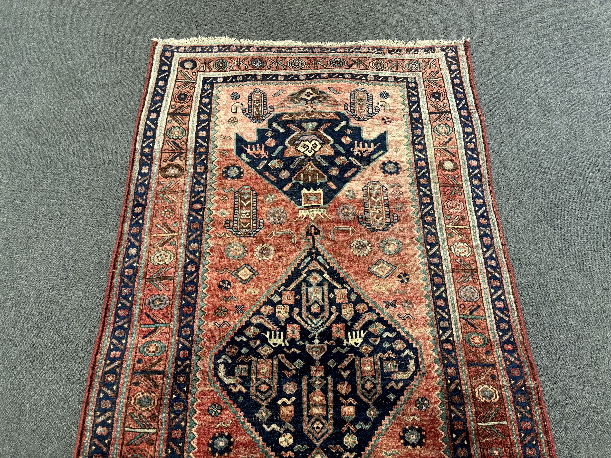An Heriz red ground medallion rug 280 x 137cm